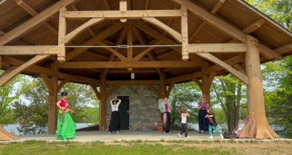 people dancing under bandshell